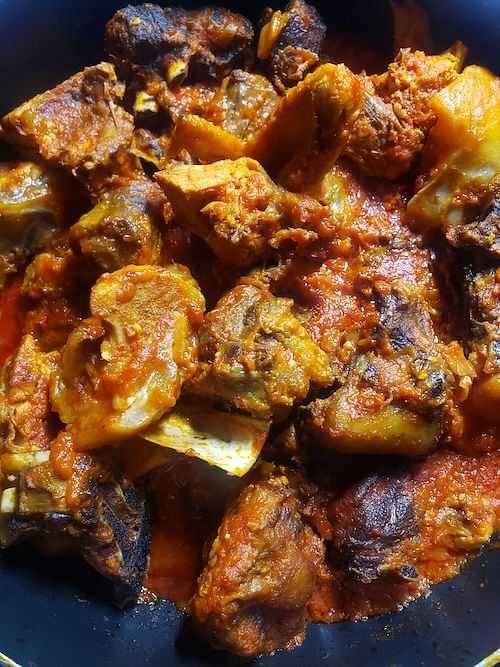 Stew with meat and potatoes in a tomato-based sauce.